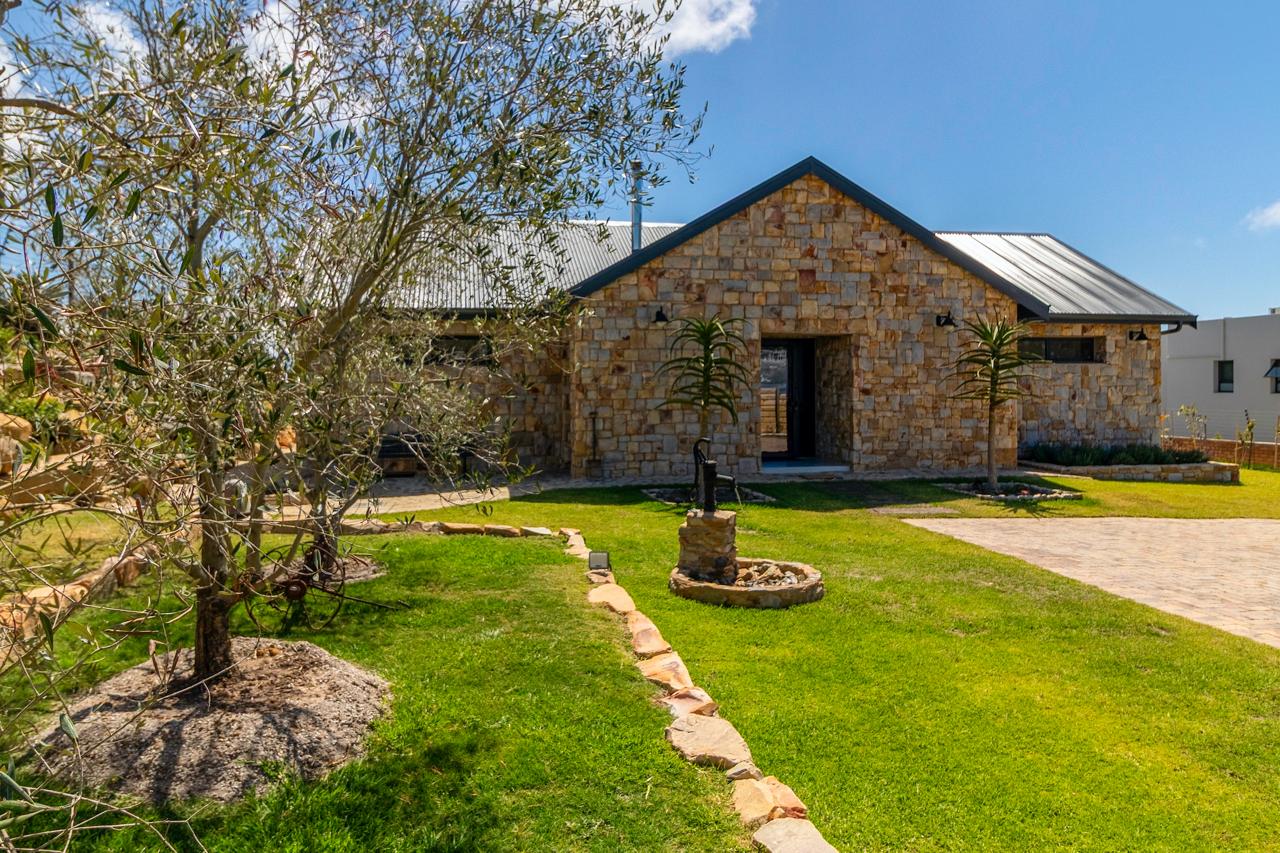 Front entrance with olive tree and manicured lawn